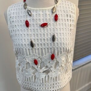 White Sleeveless Crochet Top with Red and Silver Necklace